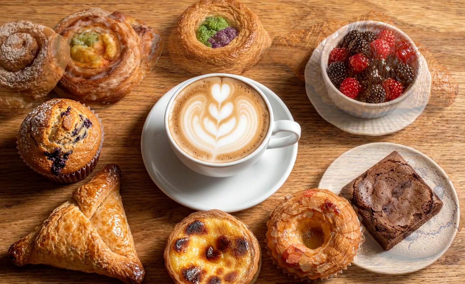 Coffee and pastry on a warm café table